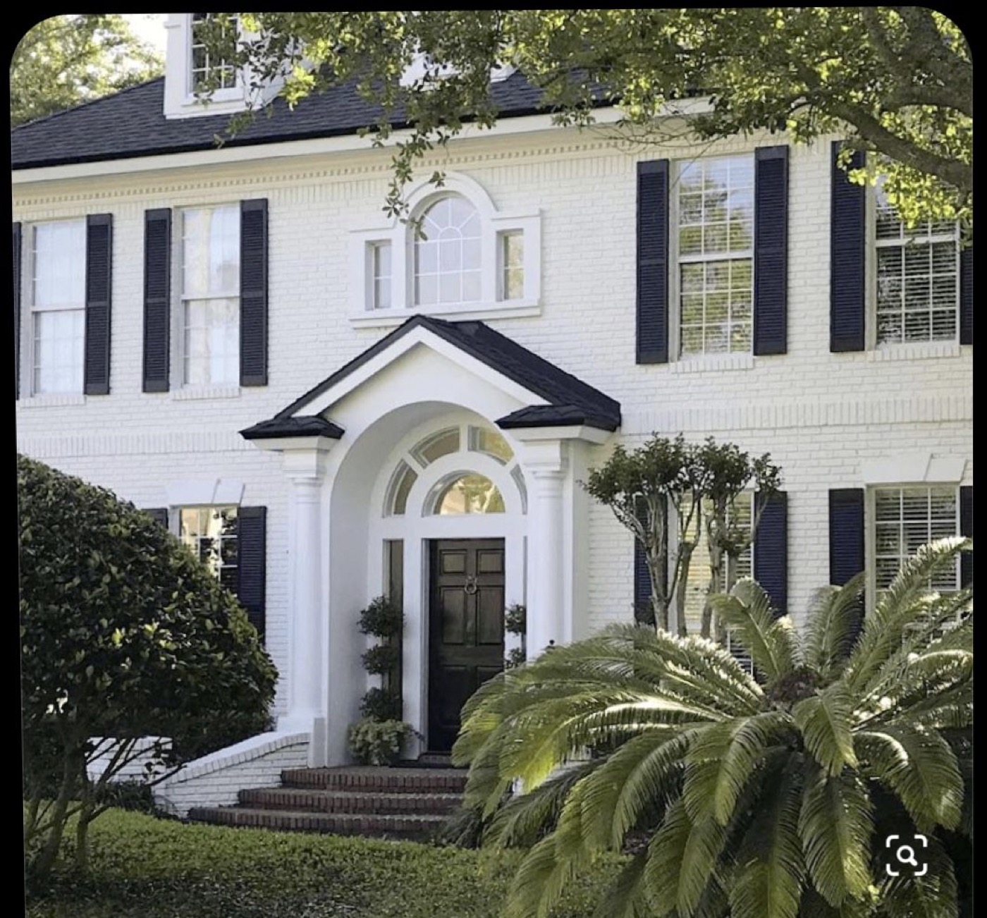 Exterior painters Raleigh NC working on a painted brick home